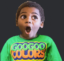 a young boy wearing a green googoo colors t-shirt