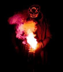 a person wearing a mask with x on it is holding a fire