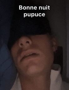 a man wearing a hat with the words bonne nuit pupuce written on it