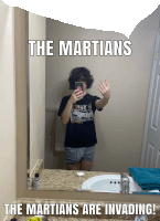 a man taking a picture of himself in a bathroom mirror with the words the martians are invading