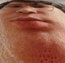 a pixelated image of a person 's face with glasses on