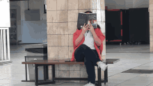 a woman sits on a bench covering her face with a book titled " a brief history "