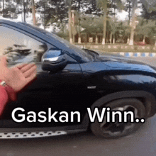 a black car with gaskan winn written on the side