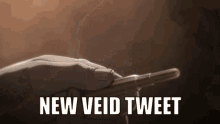 a hand is holding a bullet with the words " new void tweet " written below it