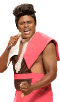 a man singing into a microphone wearing a pink outfit