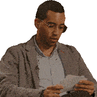 a man wearing glasses and a gray jacket is holding a piece of paper