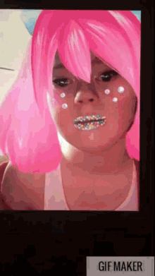 a little girl wearing a pink wig and sprinkles on her face .