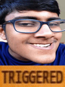 a close up of a man 's face with glasses and the word triggered on the bottom