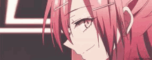 a close up of a pink haired anime girl with glasses and a smile on her face .