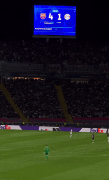 a soccer game is being played in a stadium with a fedex banner in the background