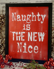 a framed christmas poster that says naughty is the new nice