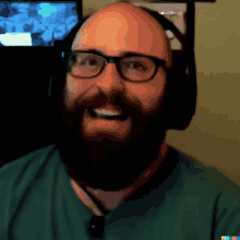 a man with a beard wearing headphones and a green shirt