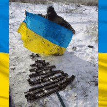 a man holding a flag in the snow with a christmas tree made of bullets