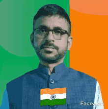 a man with glasses and a beard is wearing a vest with the flag of india on it .