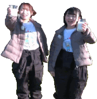 two girls are holding up glasses of milk and one has a shirt that says milk on it