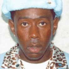 a man wearing a blue hat and a leopard print shirt