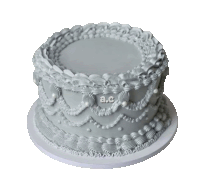 a white cake with pearls and frosting that says a.c.