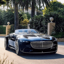 a black mercedes convertible is parked in front of a house