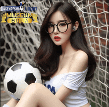 a woman wearing glasses is holding a soccer ball in front of a museum bola banner