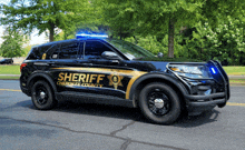 a cherokee county sheriff 's car with blue lights on