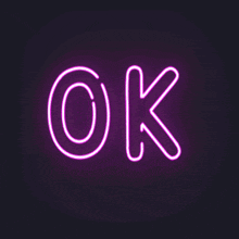 a purple neon sign that says ok on a black background