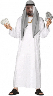 a man in a white robe is holding a pile of money