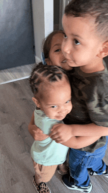 a boy and a girl are hugging each other on the floor