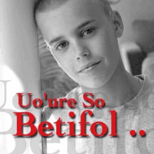 a black and white photo of a young boy with the words " uo 're so betifol " on the bottom