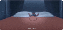 a cartoon of stitch laying on a bed with the words smol vibes below him