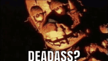 a close up of a skeleton face with the words `` dead ass '' written on it .