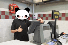 a man giving a thumbs up at a mcdonald 's counter