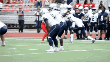 a group of football players are lined up on the field and one of them has the number 2 on his jersey