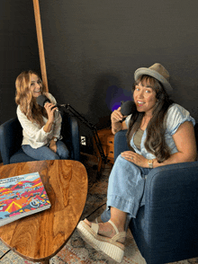 two women are sitting at a table with a book on it that says california