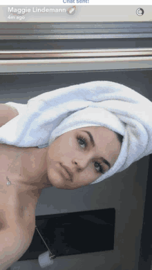 a naked woman with a towel wrapped around her head