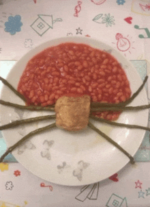 a plate of baked beans with green beans and a piece of meat on it