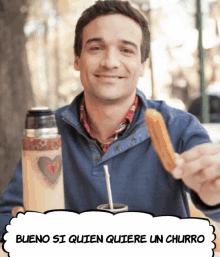 a man is holding a churro in front of a sign that says bueno si quien quiere un churro