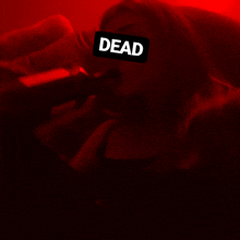 a woman with the word dead written on her face