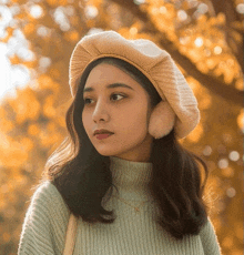 a woman wearing a sweater and a hat with ear warmers on