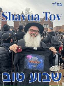 a man with a beard is holding a t-shirt that says " shabadia " on it