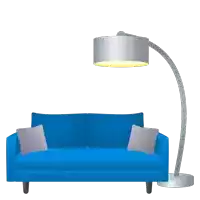 a blue couch with two pillows and a lamp