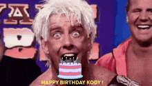 a man with a birthday cake in front of him with the words happy birthday kody below him