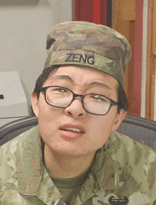 a soldier wearing glasses and a hat that says zeng on it