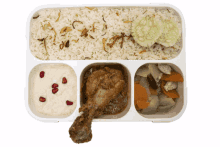 a tray of food with rice chicken vegetables and pomegranate seeds