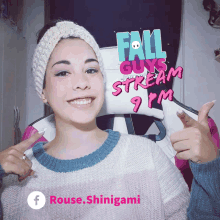 a woman giving a thumbs up in front of a sign that says fall guys stream