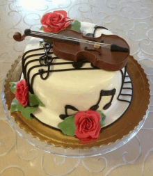 a cake with a violin and roses on top