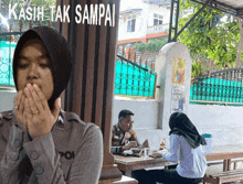 a man and a woman sit at a table in front of a sign that says " kasih tak sampai "