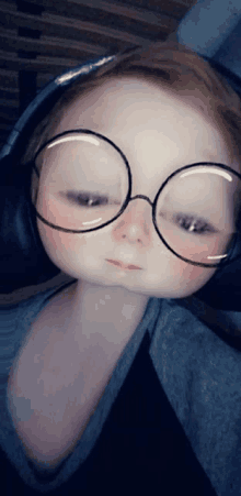 a little girl wearing glasses and headphones looks like a doll