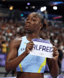 a woman holds up a sign that says alfred on it