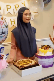 a woman is standing in front of a birthday cake