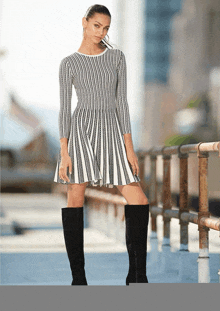 a woman in a black and white striped dress and black boots